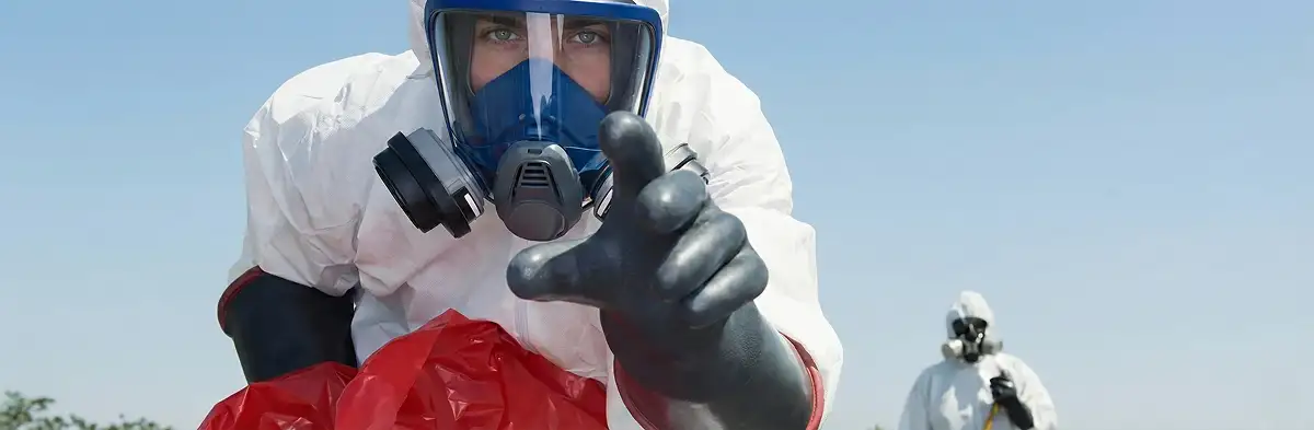 sewage clean up technician wearing protective gear handling biohazard materials in Milwaukee, WI
